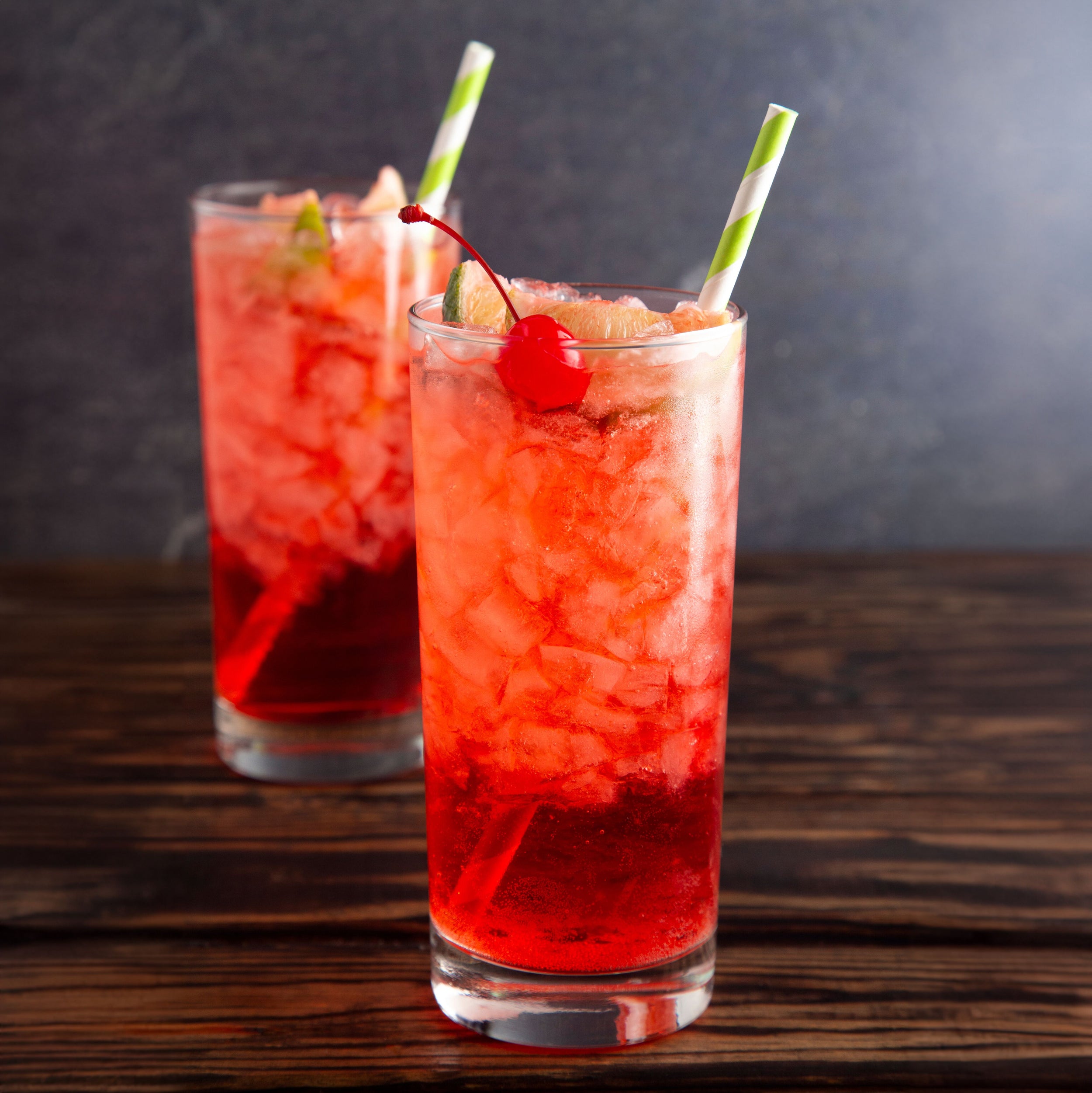 Glass of Cold Refreshing Cherry Limeade on a Wooden Table